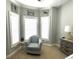 Cozy bedroom sitting area near a bay window with a comfortable reading chair and side table at 1029 Ray Costin Way # Villa 909, Murrells Inlet, SC 29576