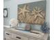 Charming nautical decor on console table features starfish art and coastal accents at 1029 Ray Costin Way # Villa 909, Murrells Inlet, SC 29576