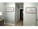 Light and airy hallway with beach themed decorations leading to bathroom with commode and sink at 1029 Ray Costin Way # Villa 909, Murrells Inlet, SC 29576