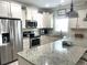 Bright kitchen with granite countertops, stainless steel appliances, and ample cabinet space at 1029 Ray Costin Way # Villa 909, Murrells Inlet, SC 29576