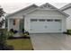 Charming home exterior features a two-car garage, manicured lawn, and traditional architectural details at 1064 Oak Meadow Dr., Conway, SC 29526