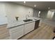 Kitchen island with granite countertops, stainless steel sink, and white cabinetry at 1064 Oak Meadow Dr., Conway, SC 29526