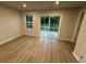 Bright living room with sliding glass doors to yard and wood-look flooring throughout at 1064 Oak Meadow Dr., Conway, SC 29526