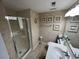 Full bathroom with modern glass shower and seashell decor at 1101 Possum Trot Rd. # A202, North Myrtle Beach, SC 29582