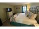 Inviting bedroom with a decorative bed and bright window at 1101 Possum Trot Rd. # A202, North Myrtle Beach, SC 29582