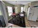 Bright dining room features a charming light fixture and adjacent kitchen at 1101 Possum Trot Rd. # A202, North Myrtle Beach, SC 29582