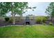 Grassy backyard features a charming fireplace, mature trees and manicured flower beds at 112 Molinia Dr., Murrells Inlet, SC 29576