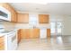 Well-lit kitchen featuring wood cabinets, laminate floors, and white appliances at 112 Molinia Dr., Murrells Inlet, SC 29576
