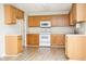 Well-lit kitchen with wood cabinets, white appliances, and laminate floors at 112 Molinia Dr., Murrells Inlet, SC 29576