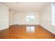 Bright living room with hardwood floors, a window, and neutral paint, offering a versatile space at 112 Molinia Dr., Murrells Inlet, SC 29576