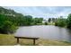Scenic view of the pond with surrounding trees and a bench at 112 Molinia Dr., Murrells Inlet, SC 29576