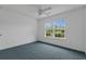 Bedroom featuring a window offering neighborhood views, accented by blue carpet and neutral wall color at 1220 Dunraven Ct., Conway, SC 29527