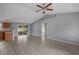 Open-concept living room showcasing the hardwood style floors and sliding doors out to the sunroom at 1220 Dunraven Ct., Conway, SC 29527