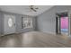 Neutral living room showcasing wood-look flooring with a door out to the sunroom and one bedroom entrance at 1220 Dunraven Ct., Conway, SC 29527