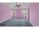 Large main bedroom featuring dual windows, ceiling fan, a tray ceiling and neutral-toned carpet at 1220 Dunraven Ct., Conway, SC 29527