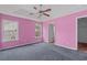 Bright main bedroom with a ceiling fan, carpet and two windows providing great natural light at 1220 Dunraven Ct., Conway, SC 29527