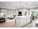 Open concept living room and kitchen area with lots of natural light and modern decor at 1308 Piper Glen Dr, Sunset Beach, NC 28468