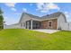 A spacious backyard featuring a screened porch, a brick accent wall, a white fence and a large green lawn at 131 Crabapple Dr., Longs, SC 29568