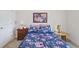 Cozy bedroom with floral bedding, framed artwork, and a classic bedside table with a lamp at 131 Crabapple Dr., Longs, SC 29568