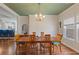 Elegant dining room with hardwood floors, a modern chandelier, and a stylish table set for six at 131 Crabapple Dr., Longs, SC 29568