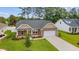 Beautiful single-story home with a well-manicured lawn and attached two-car garage at 131 Crabapple Dr., Longs, SC 29568