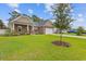 Attractive single-story house with a well-kept lawn, mature tree, and two-car garage at 131 Crabapple Dr., Longs, SC 29568