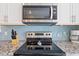 Well-equipped kitchen showcasing stainless steel appliances and a sleek design with blue backsplash at 131 Crabapple Dr., Longs, SC 29568