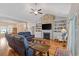 Spacious living room with a brick fireplace, built-in shelves, hardwood floors, and comfortable seating arrangements at 131 Crabapple Dr., Longs, SC 29568
