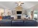 Spacious living room showcasing a fireplace with built-in shelving and comfortable seating arrangements at 131 Crabapple Dr., Longs, SC 29568