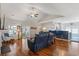 Open-concept living room featuring hardwood floors, ceiling fan, and an opening to the kitchen area at 131 Crabapple Dr., Longs, SC 29568