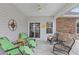 Covered patio with comfortable seating and a ceiling fan, ideal for relaxing outdoors at 131 Crabapple Dr., Longs, SC 29568