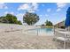 Community pool area with lounge chairs, tables, and a safety fence, perfect for relaxing and socializing at 131 Crabapple Dr., Longs, SC 29568