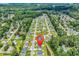 Aerial view of property highlighting community, pond, and surrounding wooded area at 135 Maggie Way, Myrtle Beach, SC 29588