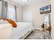 Cozy bedroom featuring a TV, neutral walls, and a large window with sheer curtains at 135 Maggie Way, Myrtle Beach, SC 29588