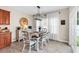 Cozy dining area featuring a modern chandelier, wooden table, and lots of natural light at 135 Maggie Way, Myrtle Beach, SC 29588