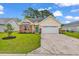 Charming single-story home featuring a manicured lawn, brick accents, and a two-car garage at 135 Maggie Way, Myrtle Beach, SC 29588