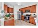Efficient kitchen featuring granite countertops, stainless steel appliances, and warm-toned cabinetry at 135 Maggie Way, Myrtle Beach, SC 29588