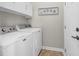 Functional laundry room featuring a white washer and dryer set with upper cabinets for storage at 135 Maggie Way, Myrtle Beach, SC 29588
