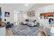 Bright living room with comfortable seating, a gallery wall, and an open layout to kitchen area at 135 Maggie Way, Myrtle Beach, SC 29588
