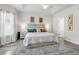 Bright main bedroom with a tray ceiling, neutral walls, and a large patterned rug at 135 Maggie Way, Myrtle Beach, SC 29588