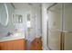Light-filled bathroom with double vanity, mirrors, and a glass-enclosed shower at 153 Wimbledon Way # 153, Murrells Inlet, SC 29576