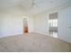 Bright bedroom with neutral carpet, ceiling fan, and ensuite bathroom access at 153 Wimbledon Way # 153, Murrells Inlet, SC 29576