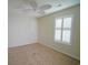 Bedroom showcasing neutral carpet, light walls, ceiling fan, and plantation shutters for a bright ambiance at 153 Wimbledon Way # 153, Murrells Inlet, SC 29576
