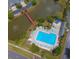 Aerial view showcasing the community pool with ample seating and manicured landscaping at 153 Wimbledon Way # 153, Murrells Inlet, SC 29576