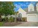 This inviting townhome features a well-manicured yard with trees and shrubs at 153 Wimbledon Way # 153, Murrells Inlet, SC 29576