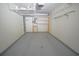 Spacious garage provides ample storage with shelving units and a clean, gray epoxy floor at 153 Wimbledon Way # 153, Murrells Inlet, SC 29576