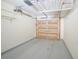 Open garage features a gray epoxy floor, shelving, and insulated garage door for energy efficiency at 153 Wimbledon Way # 153, Murrells Inlet, SC 29576