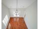 Hardwood flooring and natural light from plantation shutters accent the home's entryway with stylish chandelier at 153 Wimbledon Way # 153, Murrells Inlet, SC 29576