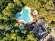 Aerial view of the community's large pool, hot tub, and pavilion amidst lush greenery at 1550 Spinnaker Dr. # 3123, North Myrtle Beach, SC 29582