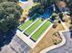 Aerial view of bocce ball courts at the community center, nestled amongst mature landscaping at 1550 Spinnaker Dr. # 3123, North Myrtle Beach, SC 29582
